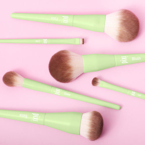 Set of Pixi makeup brushes with green handles on a pink background view 2