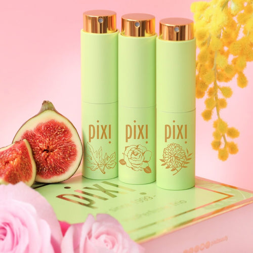 PixiPerfume Gift Trio shown on a pink background with plants  view 1